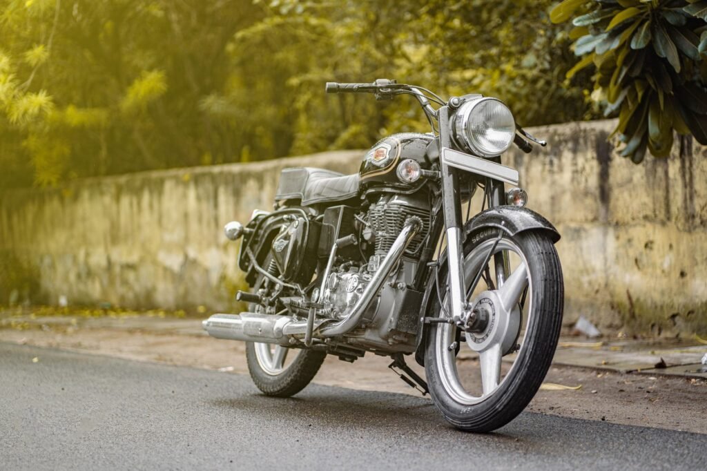 A vintage Royal Enfield motorcycle parked on a street in New Delhi, India, showcasing its classic design.