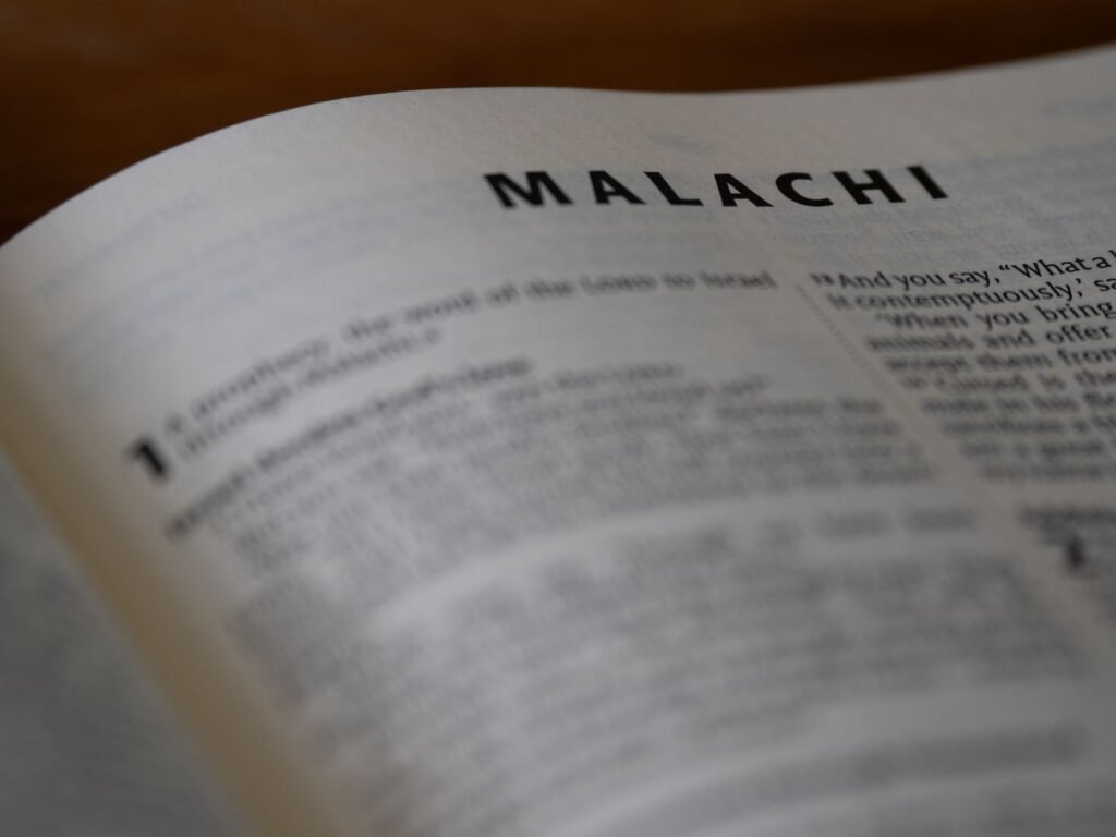 A close-up view of the Book of Malachi in an English Bible, highlighting religious texts.