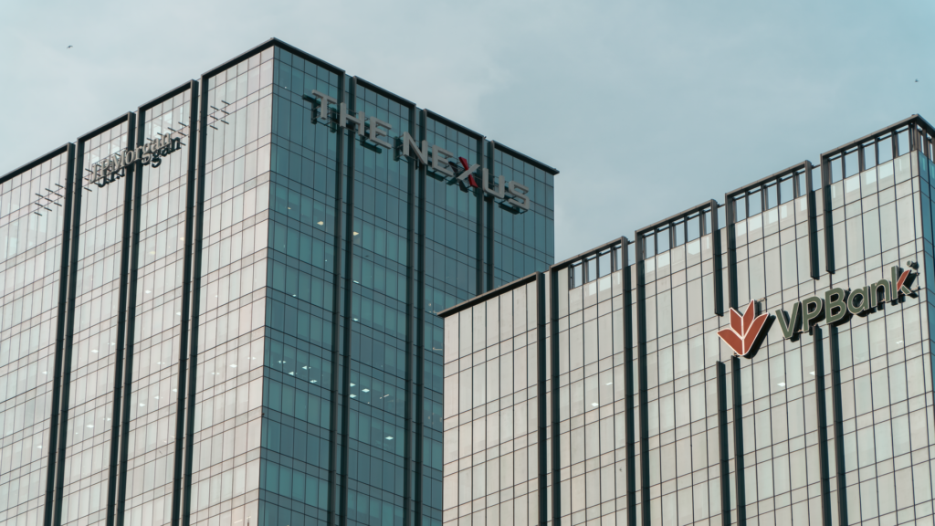 Modern glass skyscrapers featuring JP Morgan and VPBank logos in Hanoi.