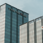 Modern glass skyscrapers featuring JP Morgan and VPBank logos in Hanoi.
