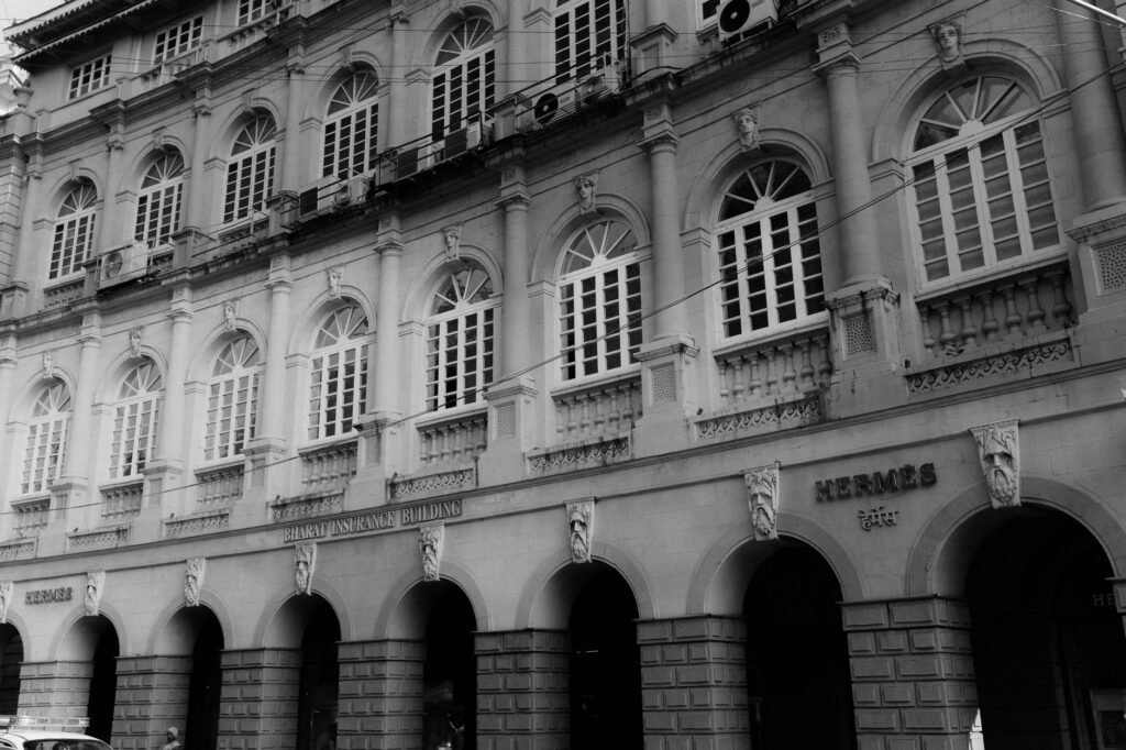 Black and white photo of the Bharat Insurance Building showcasing colonial architecture.